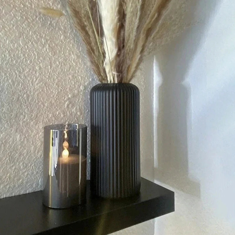 White and black ceramic-look striped plastic vases grouped together
