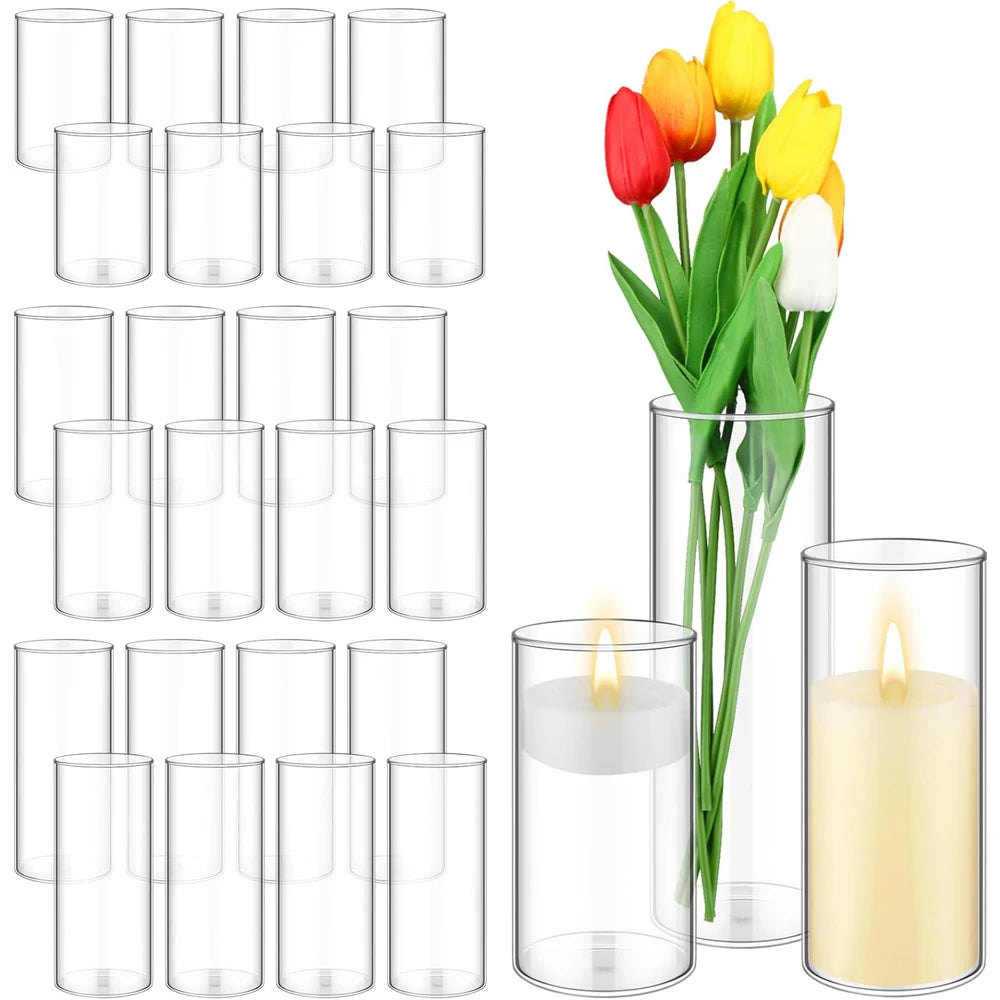 Set of twelve clear glass cylinder vases arranged as wedding table centrepiece