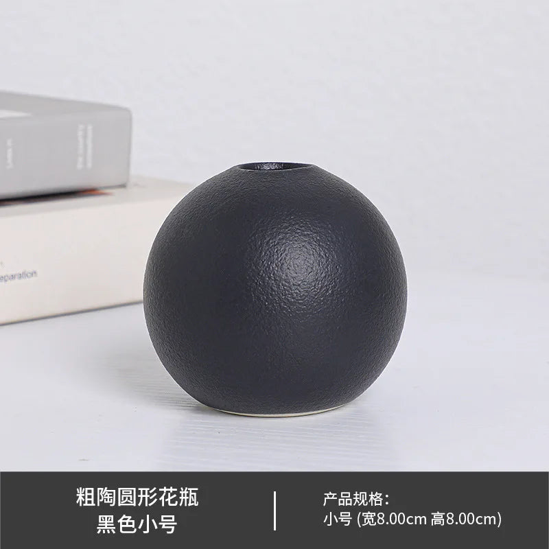 White large ball ceramic vase as statement floor piece in bright entryway