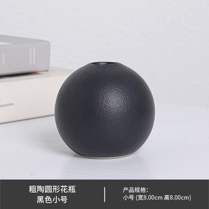 White large ball ceramic vase as statement floor piece in bright entryway