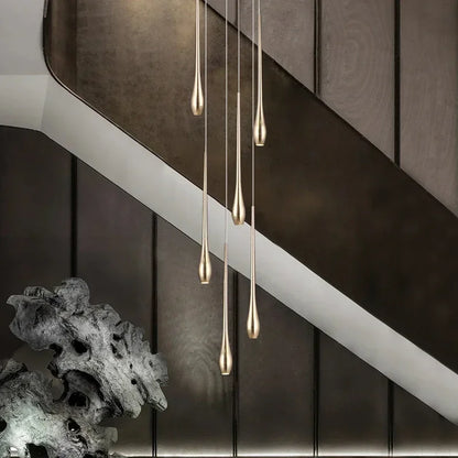 Fifteen light branch chandelier in gold running a long restaurant table