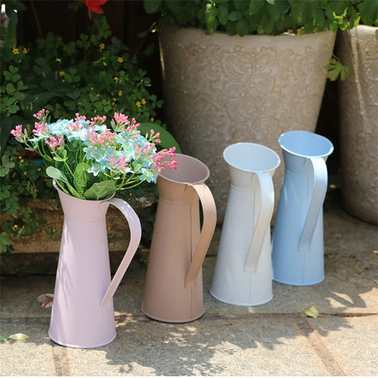 Vintage cream metal pitcher vase with flowers on shelf