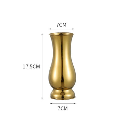 10 inch gold steel stem vase styled next to candle holders on mantel shelf