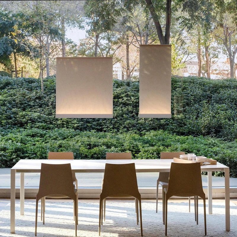 Wabi sabi pendant lit in warm 3000K light above a dining table