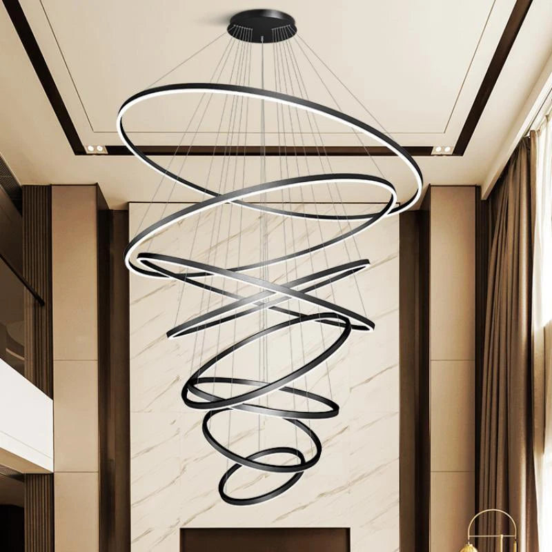 Acrylic ring staircase chandelier with five stacked rings on an iron frame