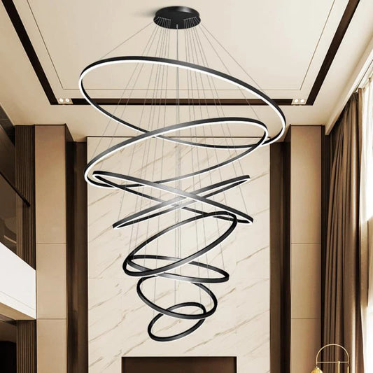 Acrylic ring staircase chandelier with five stacked rings on an iron frame