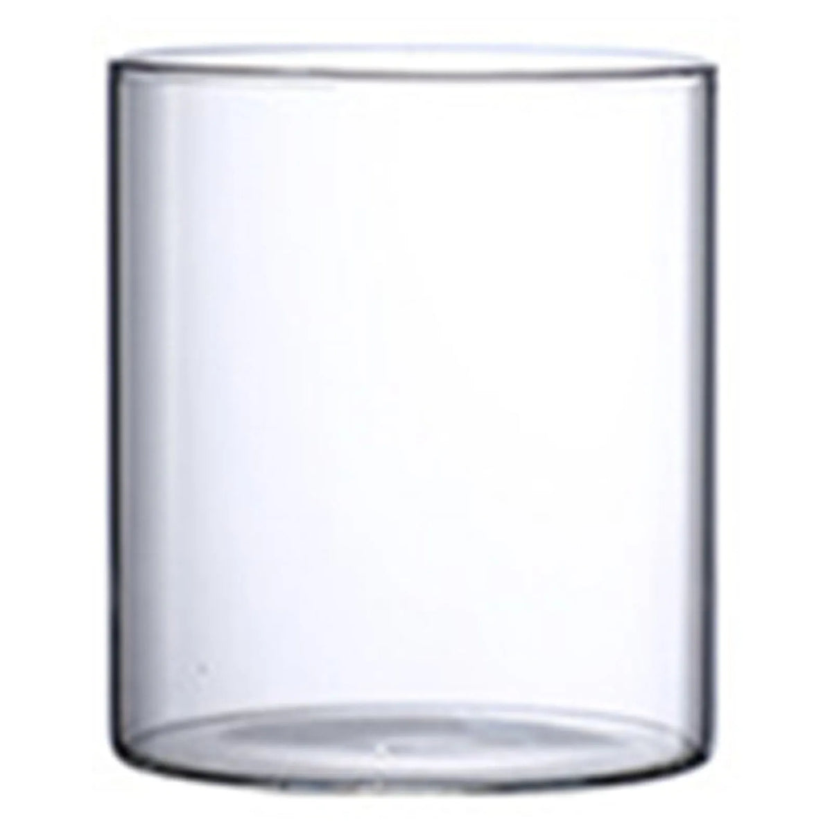 Glass cylinder bud vase with white cotton stem on neutral linen textured surface