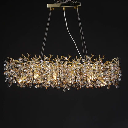 Crystal branch detail on a gold chandelier frame with warm 3000K light sources