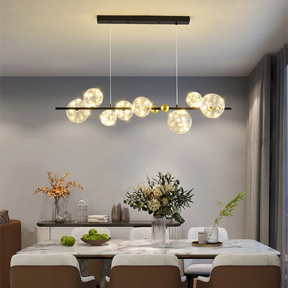 Gold chandelier with glass shades in arrangement B over a dining table