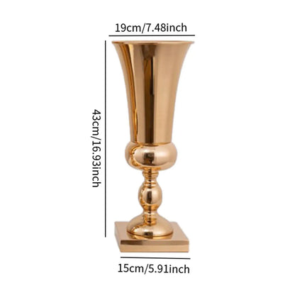 Gold metal vase stand with tropical leaves and tall floral arrangement display