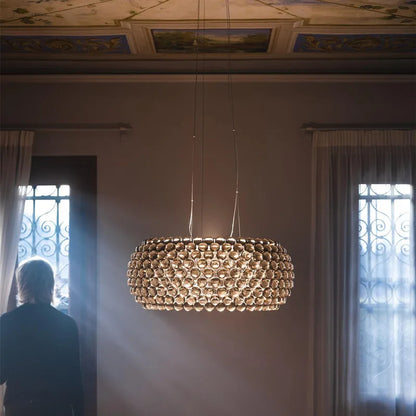 Transparent beads strung across the chandelier plated chrome frame