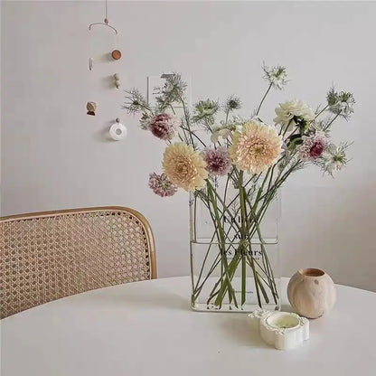 Style B acrylic book vase with slightly wider form holding mixed small flower bouquet