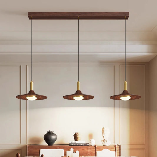 Walnut painted metal chandelier with a broad lit shade on a cord