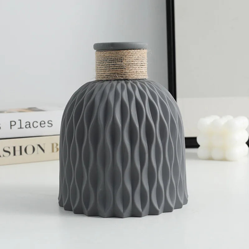 Water ripple plastic vase with twine detail on Scandinavian home shelf