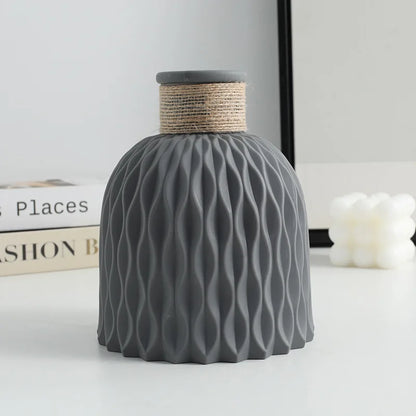 Water ripple plastic vase with twine detail on Scandinavian home shelf