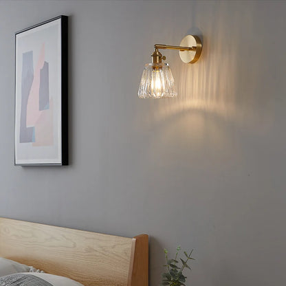 brass bathroom wall sconce, installed in a room interior setting