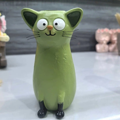 Green cat-shaped resin vase angled view showing elongated neck and sculpted figure detail