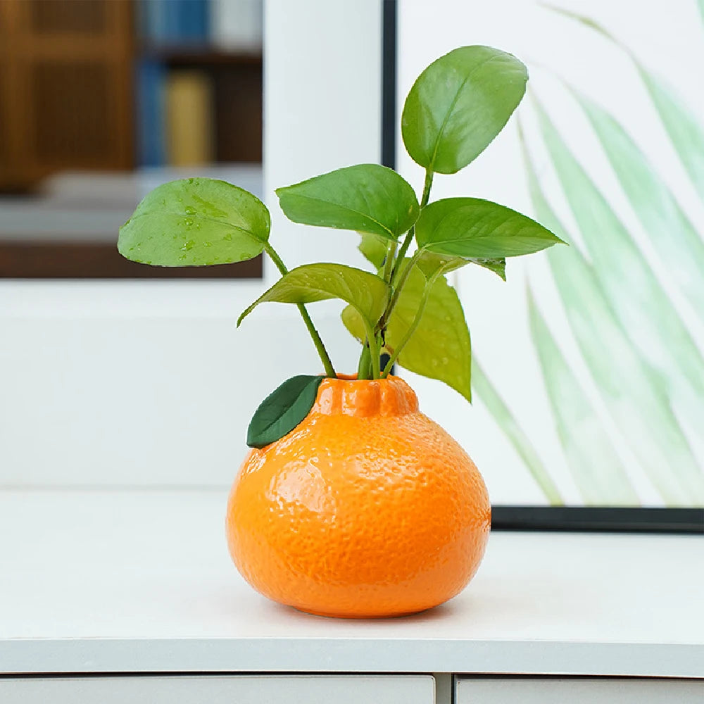 Ceramic orange fruit shaped table vase on dining room centerpiece display