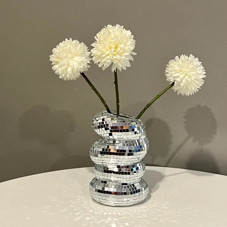 Close-up of faceted mirrored surface on glass disco ball vase