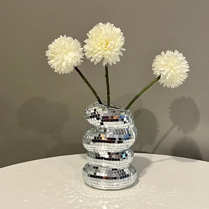 Close-up of faceted mirrored surface on glass disco ball vase