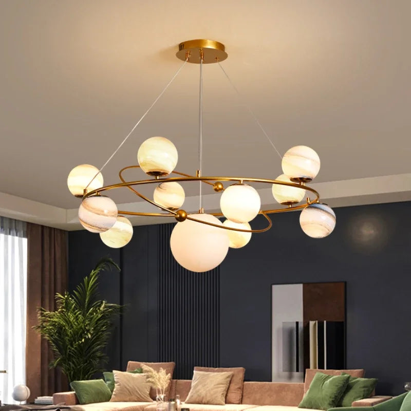 Four head planet globe chandelier in a gold plated iron finish