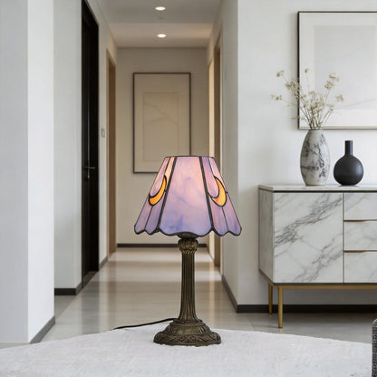 Tiffany glass lamp on bedroom desk purple hue filling the room