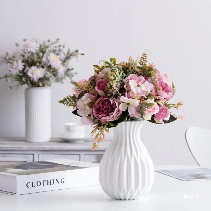 White plastic imitation ceramic vase with smooth matte finish on a Nordic shelf