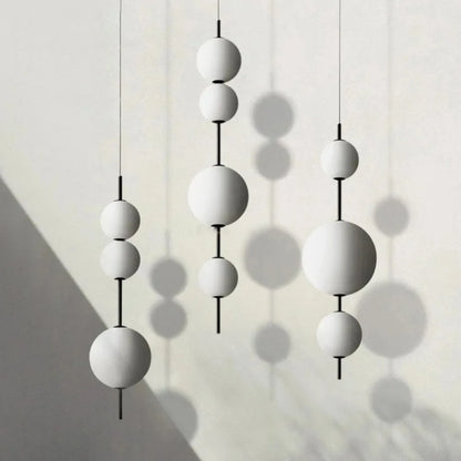 White glass ball chandelier with opal spheres stacked down a slender stem