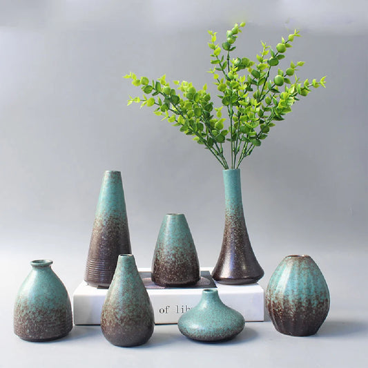 Matte black Japanese ceramic bud vase in organic wabi-sabi shape H on desk