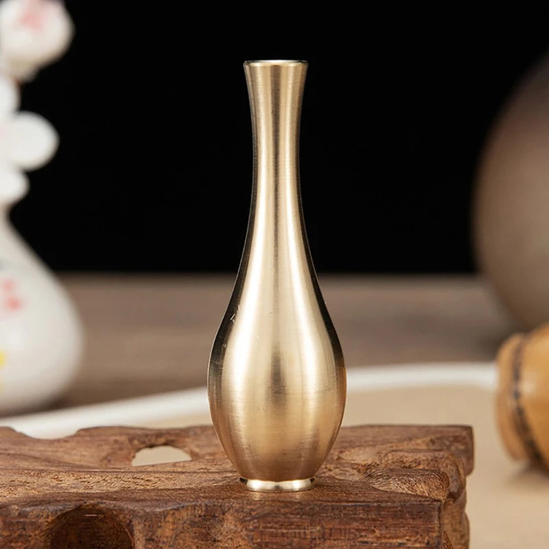White ceramic-look striped plastic vase with dried pampas grass stem
