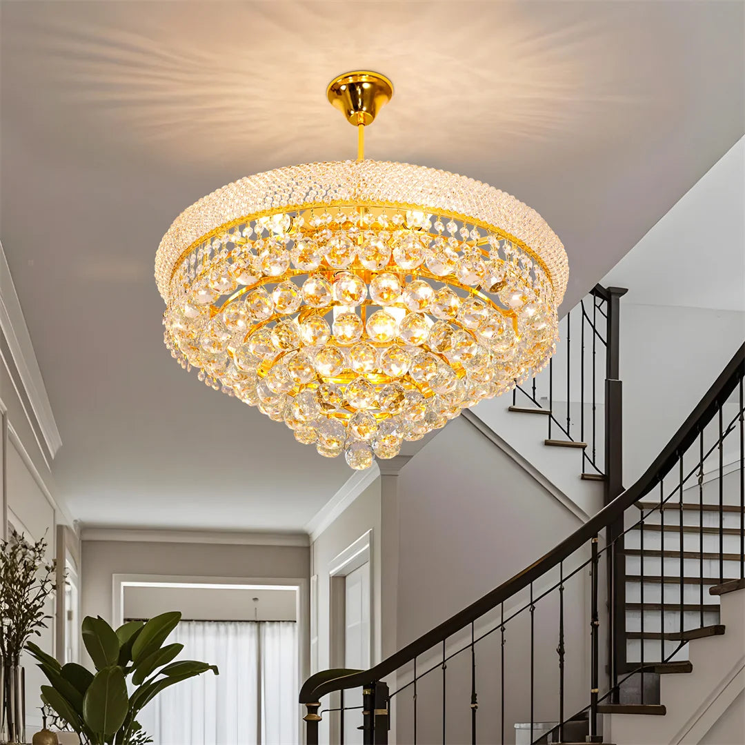 Precision cut crystal cascading from a polished gold empire frame
