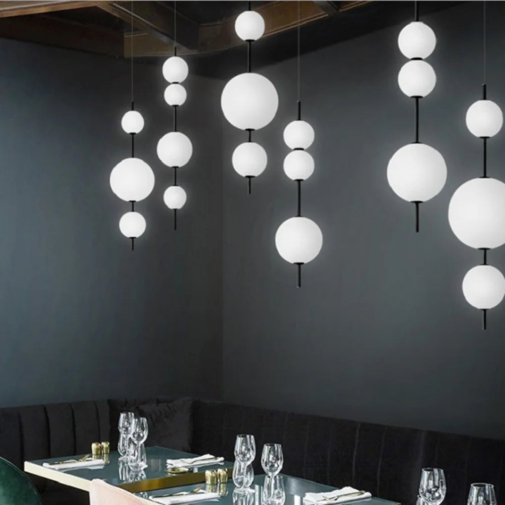 Four ball glass chandelier at 103 centimetres high with warm light