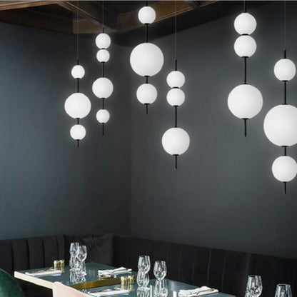 Four ball glass chandelier at 103 centimetres high with warm light