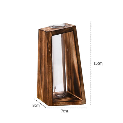 Close-up of natural wood frame holding clear glass vessel for propagation