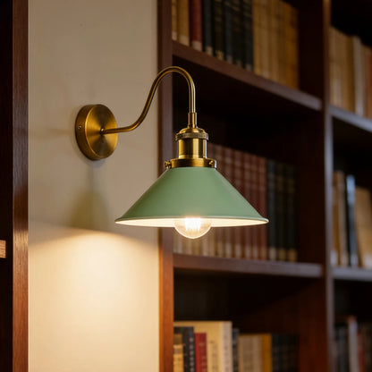 green brass wall sconce, installed in a room interior setting