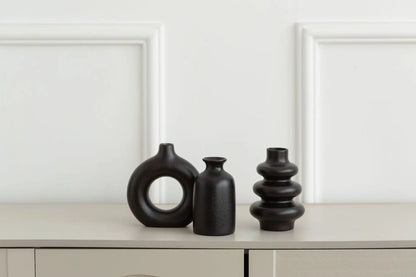 Black ceramic bohemian vase set displayed as living room console accent