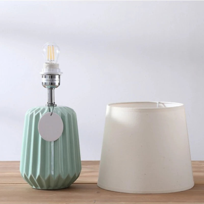 Close-up of fabric lampshade texture on white ceramic table lamp