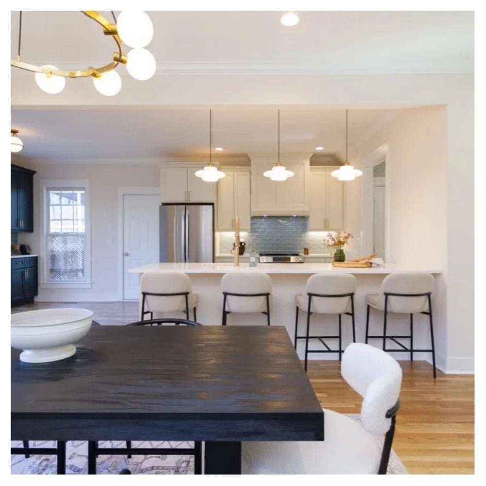 Spherical milk glass chandelier shade fixed to its metal fitting