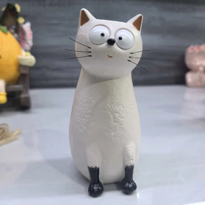 Yellow resin kitten novelty vase on decorative shelf display with other home accents
