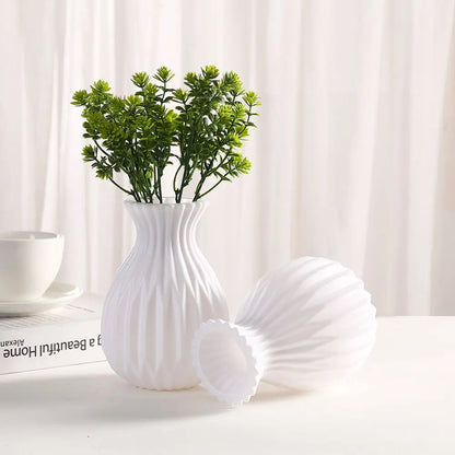 Close-up of white plastic vase surface showing smooth matte imitation ceramic finish