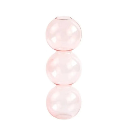 Three glass vases in color gradient arrangement from transparent to pink to blue
