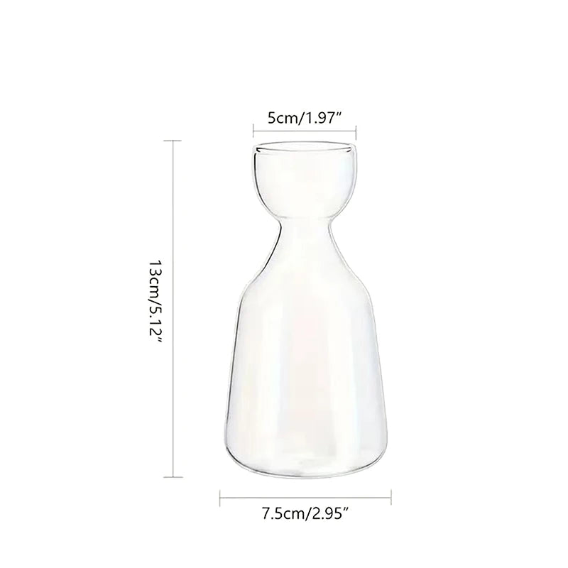 Glass avocado starter vase styled on botanical home shelf