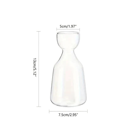 Glass avocado starter vase styled on botanical home shelf
